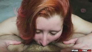 Chubby redhead doing a deepthroat on a big black cock